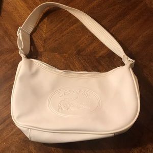 White Lacoste shoulder bag.